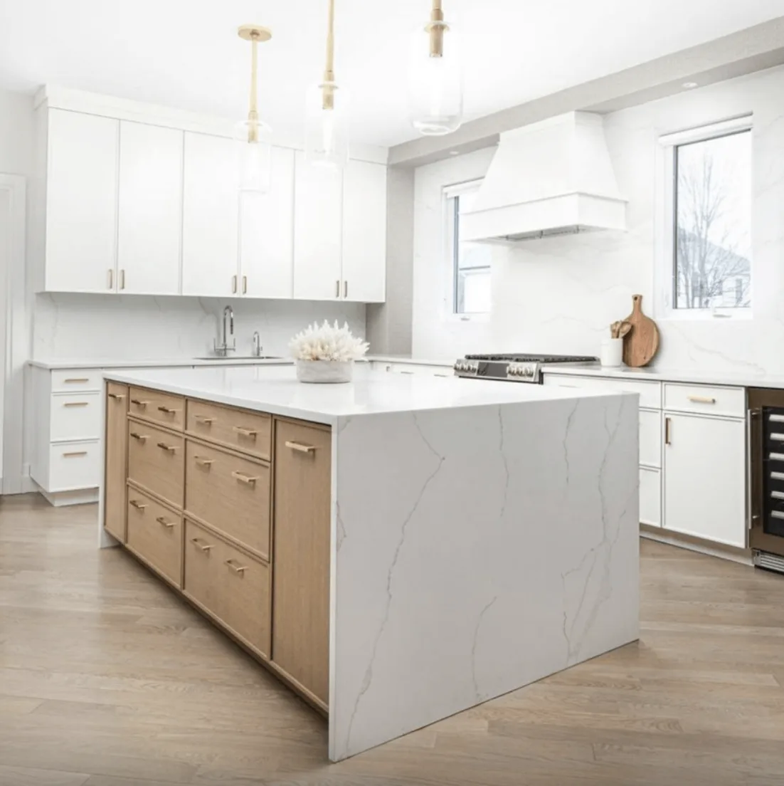 White kitchen with Borghini Gold quartz counters and island seating
