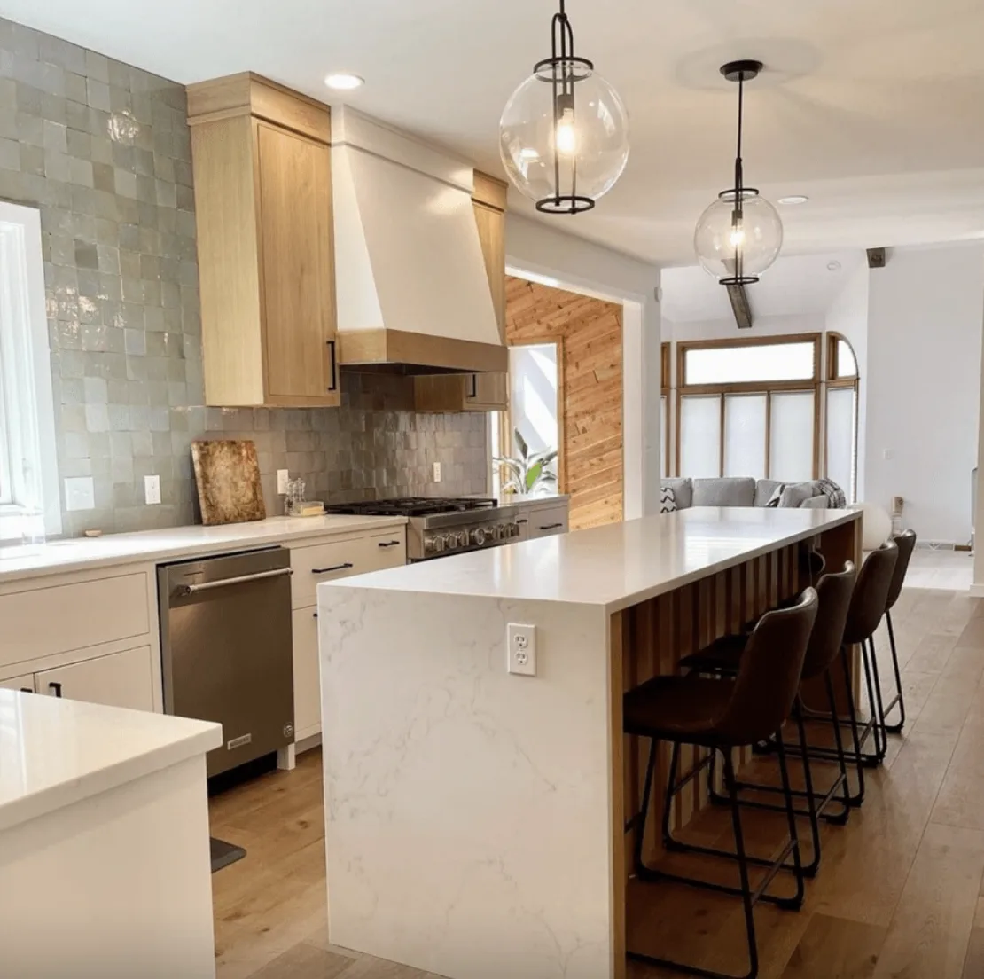 Calacatta Extra quartz island with seating in a wood tone kitchen