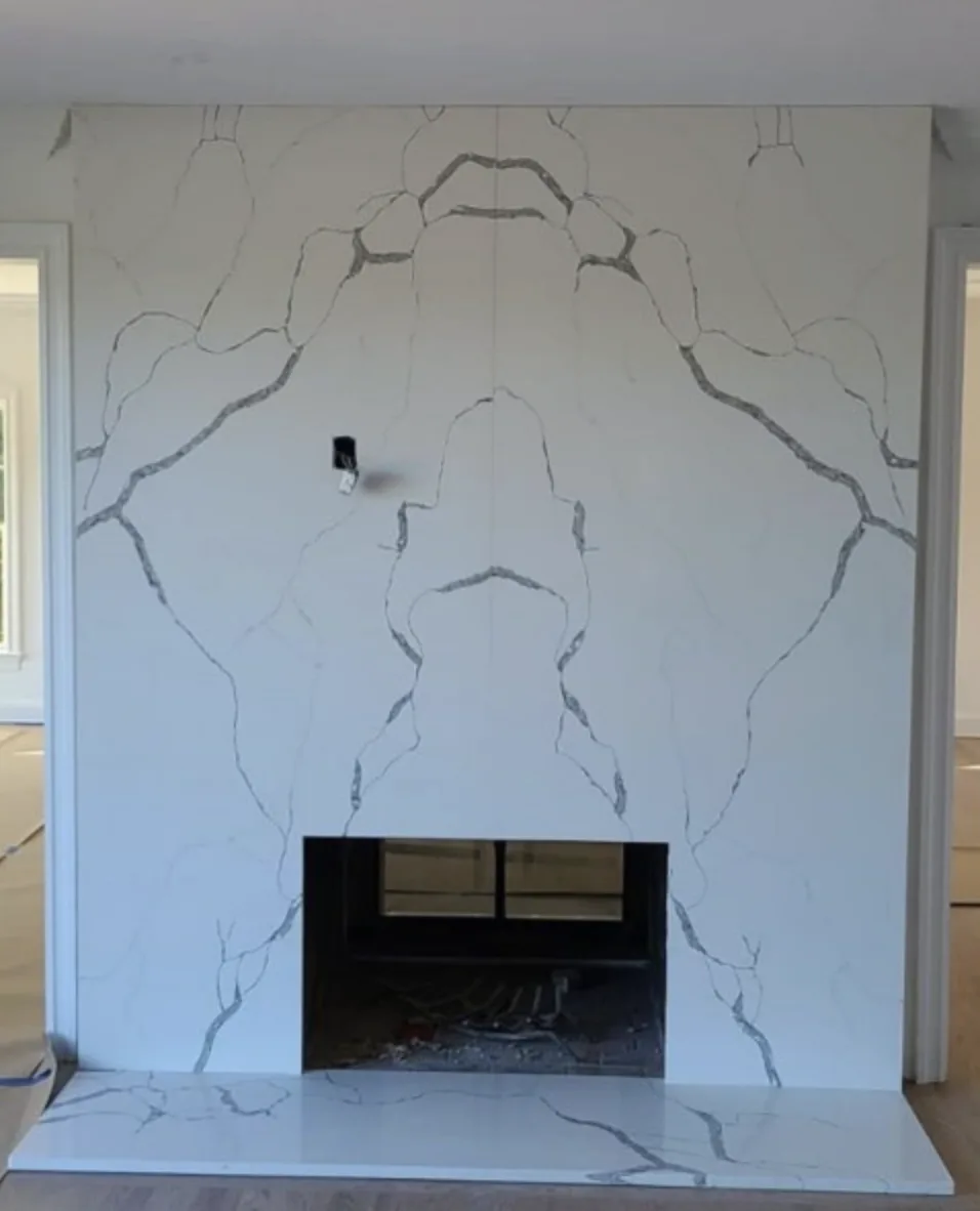 Calacatta Ivy slab fireplace surround with bookmatched veining