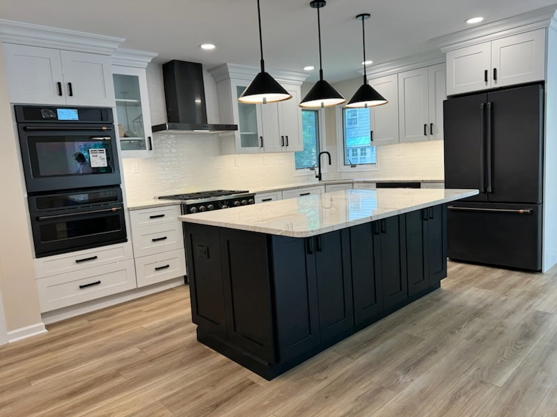 Finished white quartz island countertop on navy cabinets