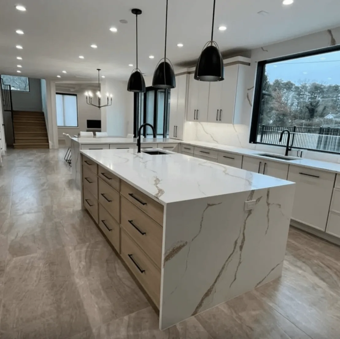 Empire Gold quartz island countertop in a white kitchen