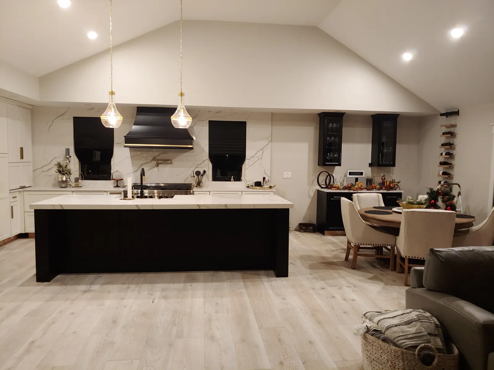 Dark island with a white stone top under a black range hood
