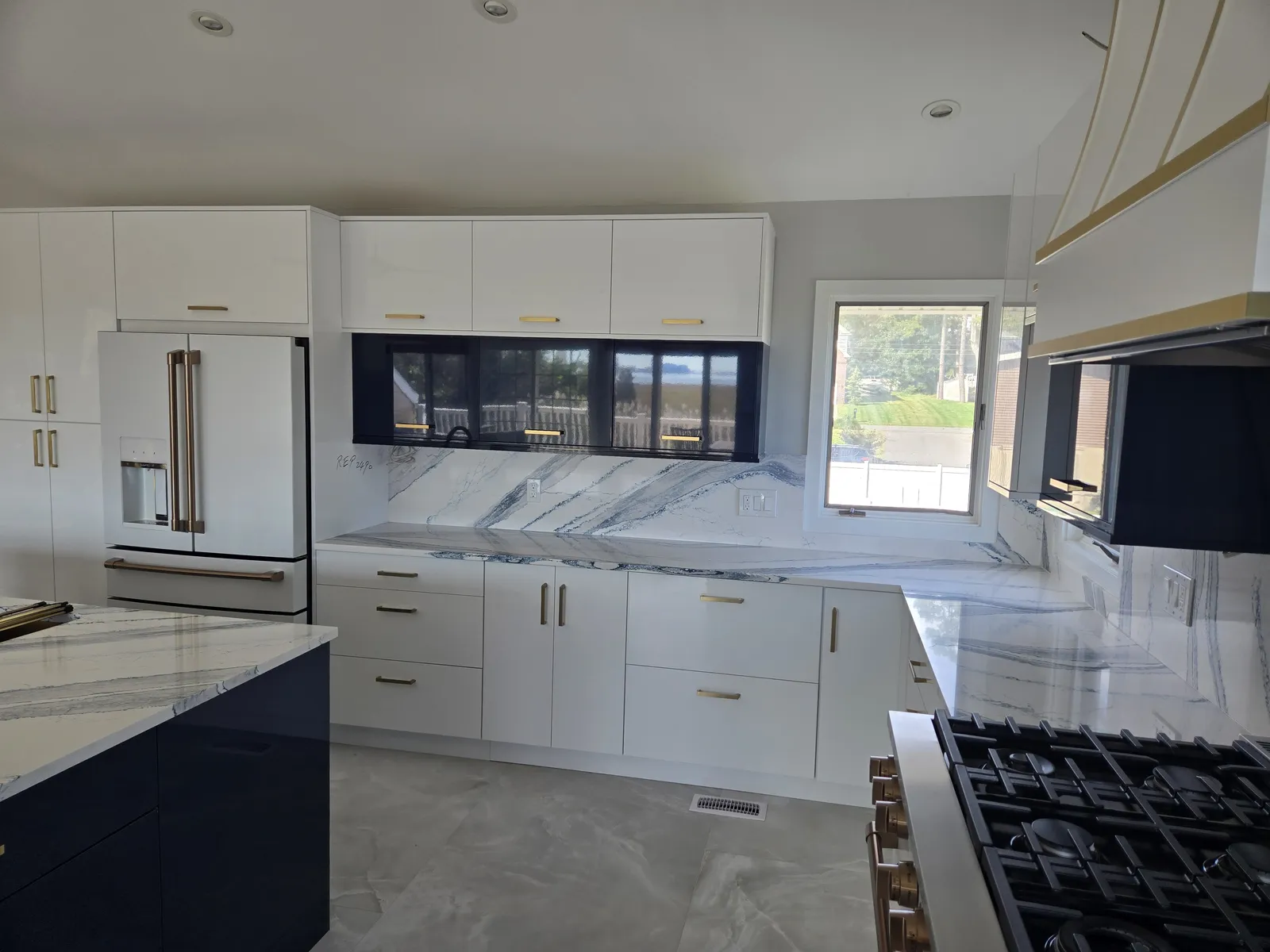 Navy island with a veined stone top and matching perimeter counters