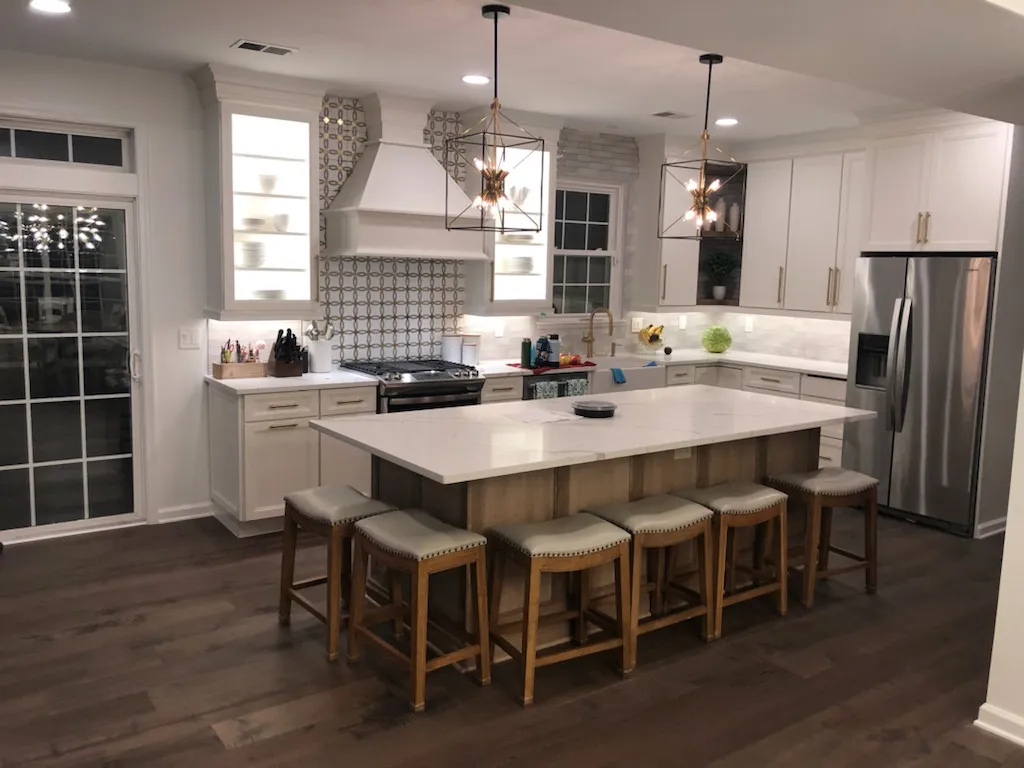 Stone island with seating in a white shaker kitchen