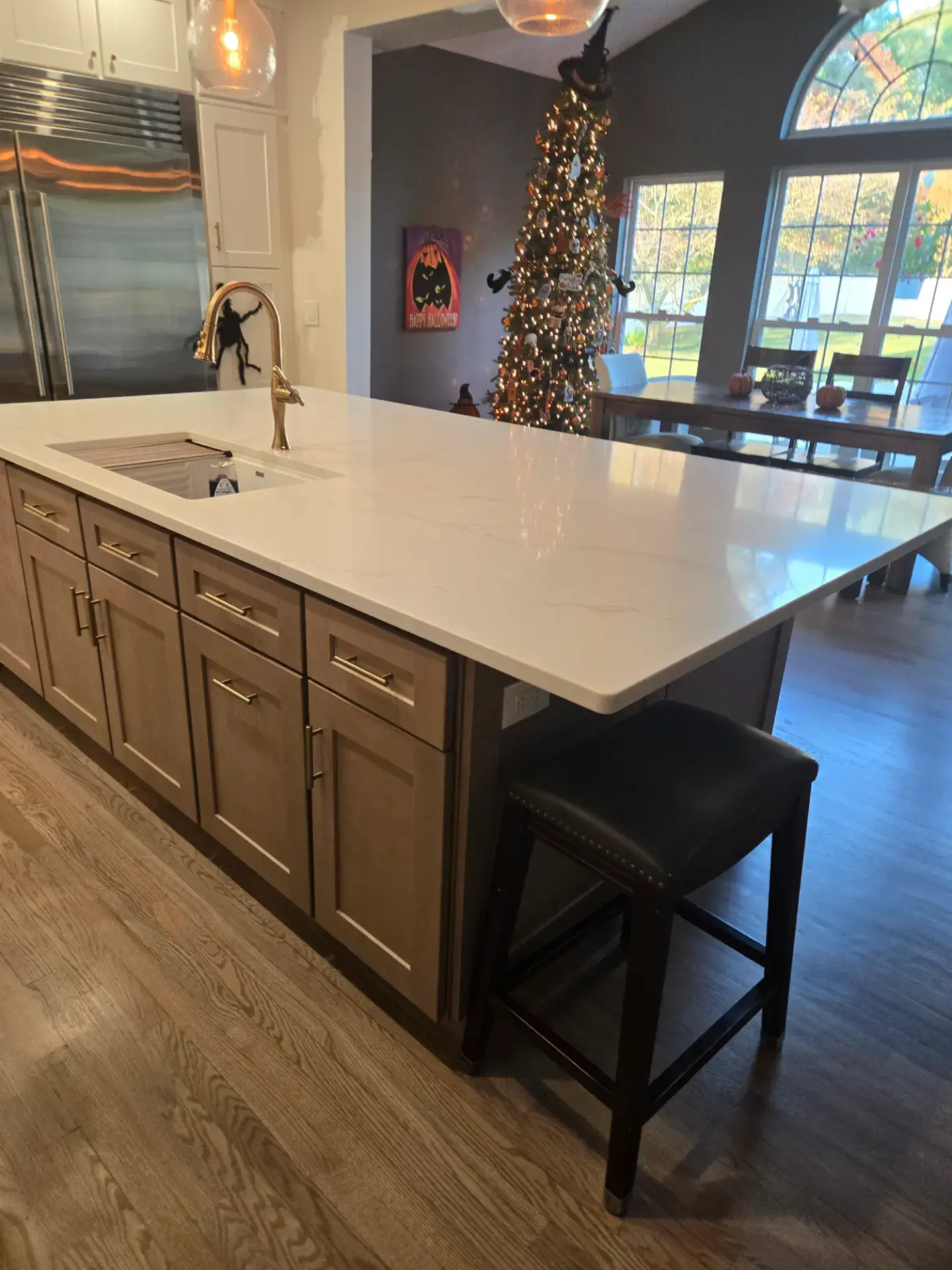 Stained wood island with a white veined stone top