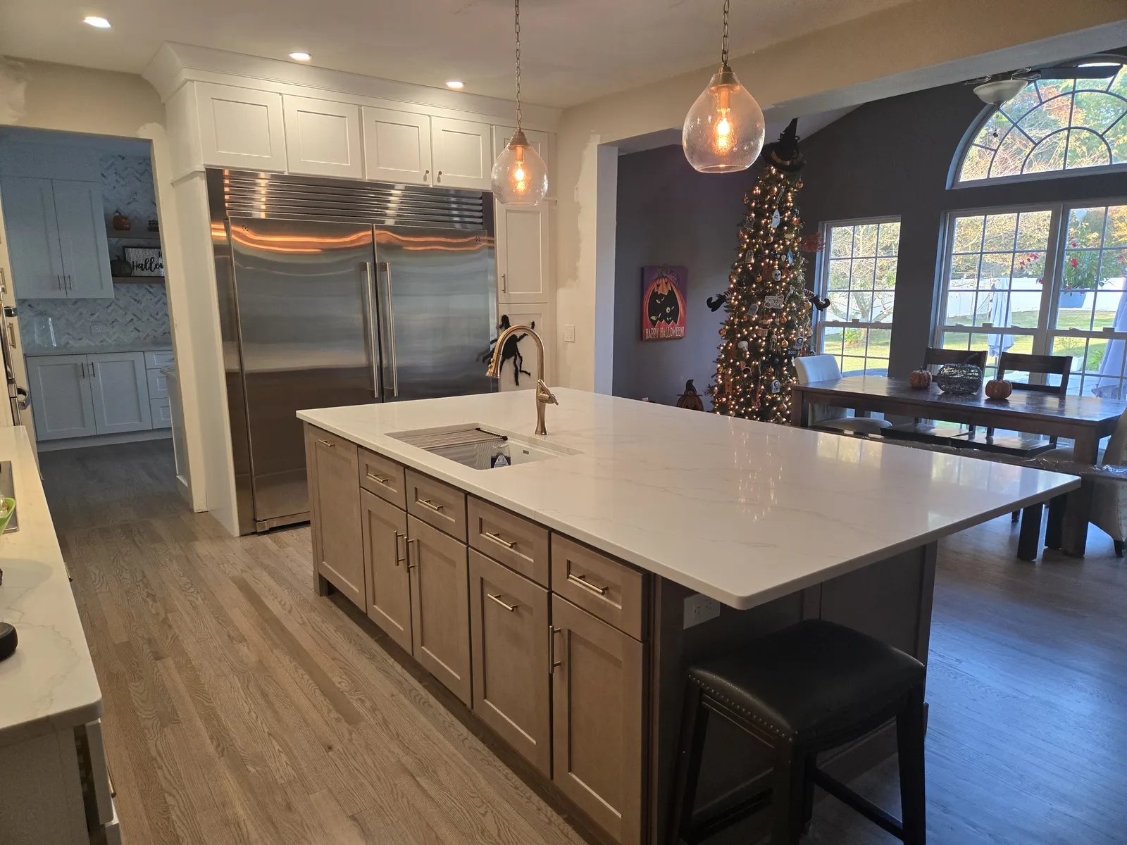 Wood island with a white stone top and pendant lights