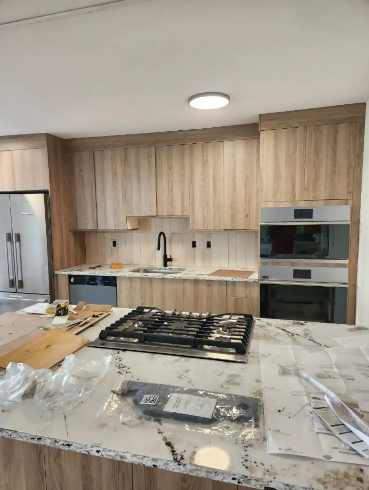 Dramatic veined stone countertop with a cooktop set into it